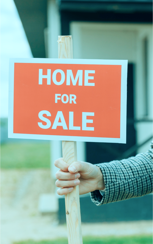 Real Estate Agent holding a sign